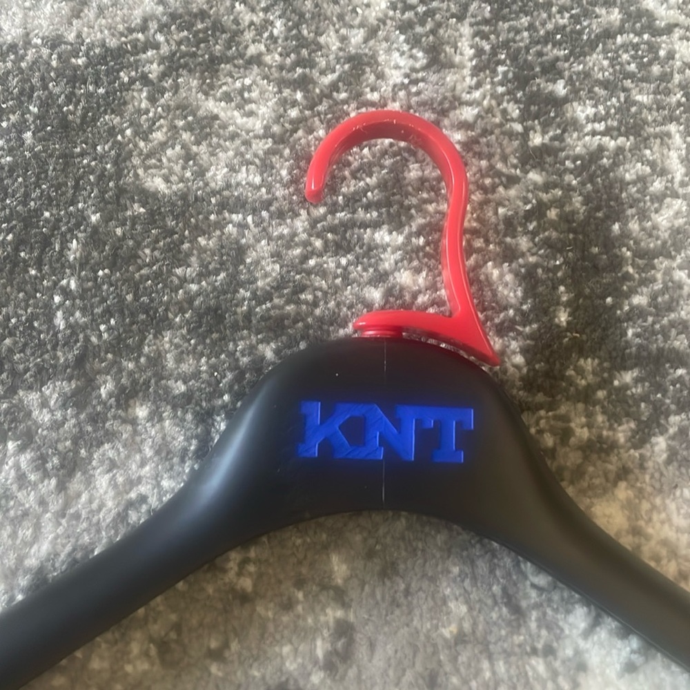 Authentic KNT Wooden hanger with plastic swiveling hook for easy rotation